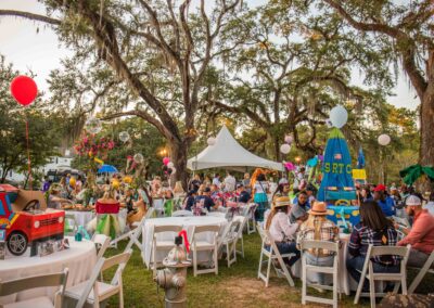 tables and tents outdoors with people at a party